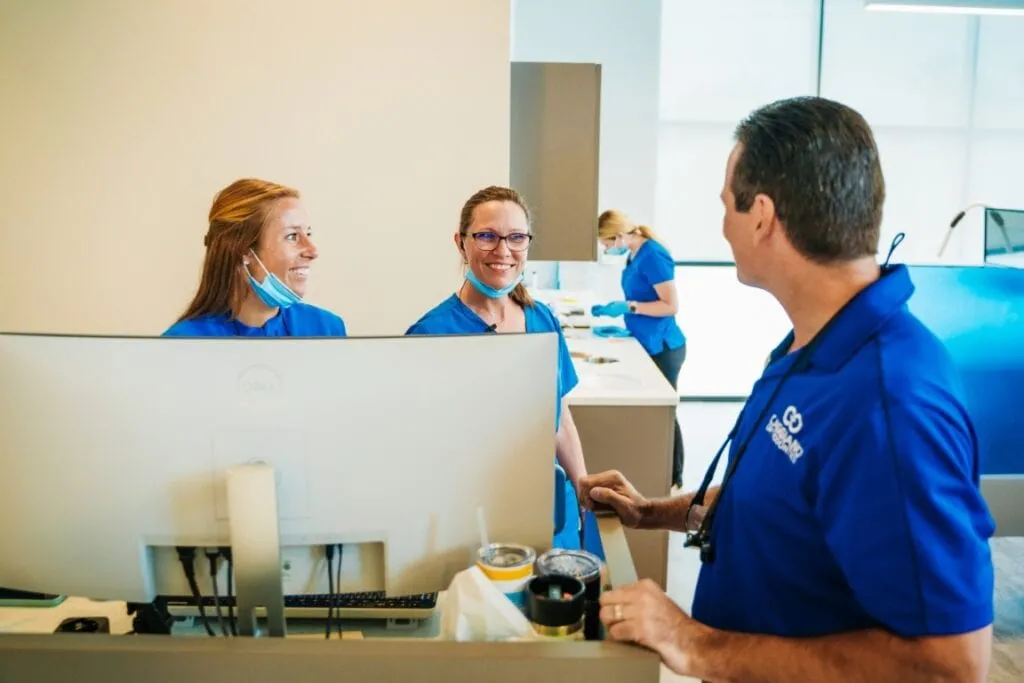 Dr. Caggiano with staff members at front desk